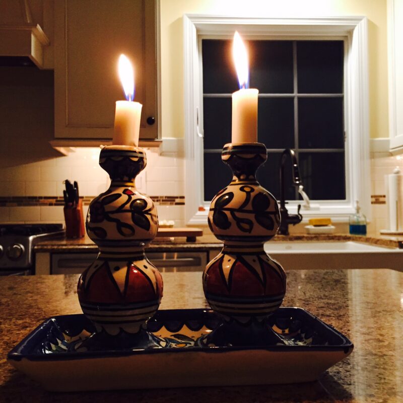 Lit Shabbat candles on table