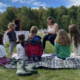 A group of children outdoors during a family Shabbat service.
