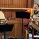 Rabbis Jarah & Rachel singing & playing guitar at Jewish Journeys Shabbat.
